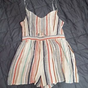Short, colorful romper with pockets.